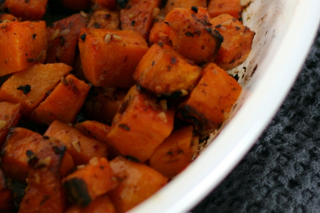 Cooked cubed sweet potatoes in baking dish