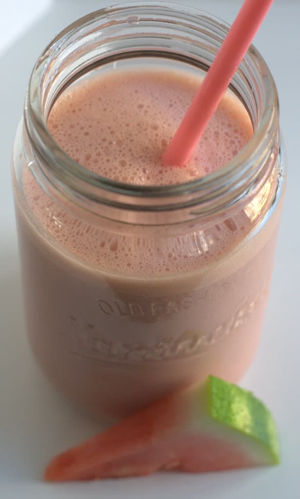 watermelon smoothie in jar with straw