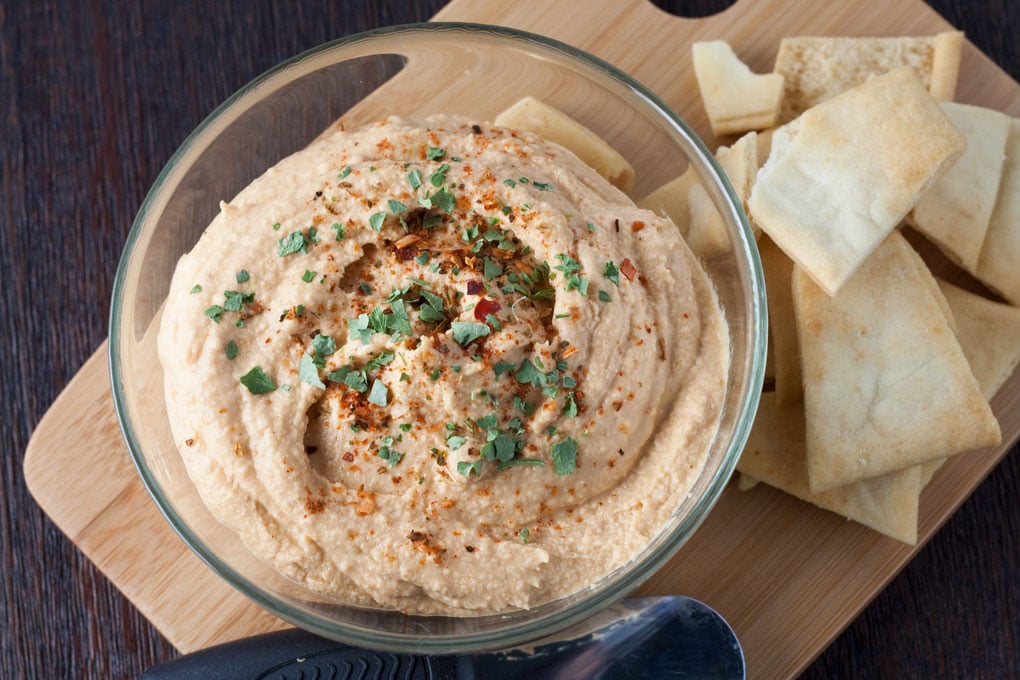 hummus served in bowl with pita chips