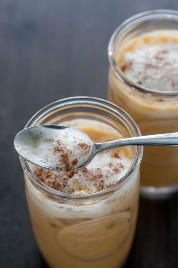 A pumpkin iced latte helps ease the transition from Summer to Fall. This drink is super easy to make and will have you smiling in minutes.
