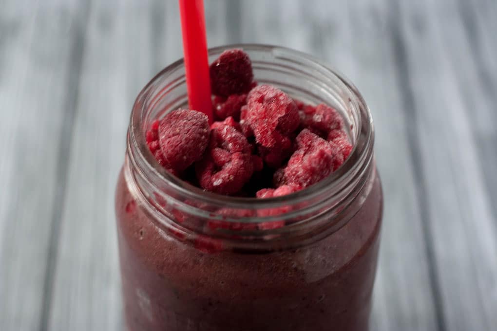 Berry Pineapple Peach Green Protein Smoothie - a great way to start your day off right. This recipe calls for plant protein powder so this is vegan/vegetarian friendly.