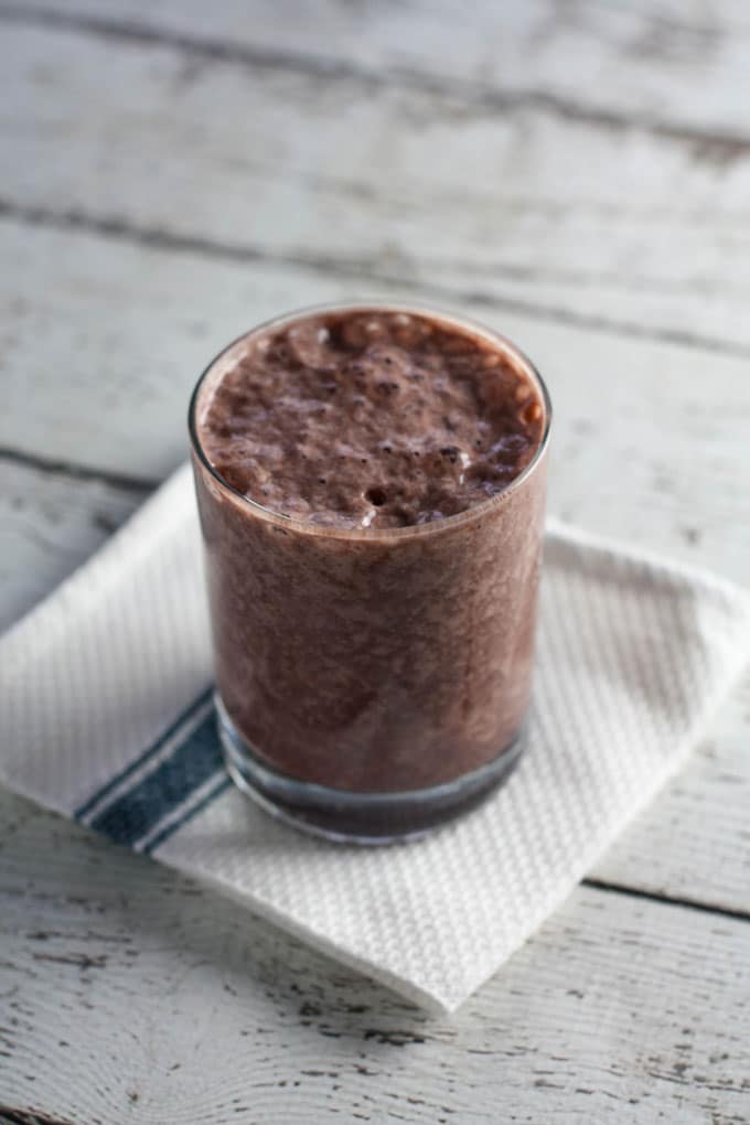 Smoothie in glass on top of white dishcloth