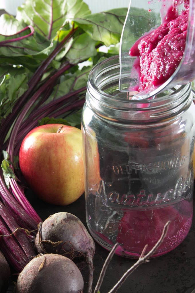 Smoothie being poured into glass jar