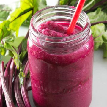 Smoothie in Mason jar surrounded by beets