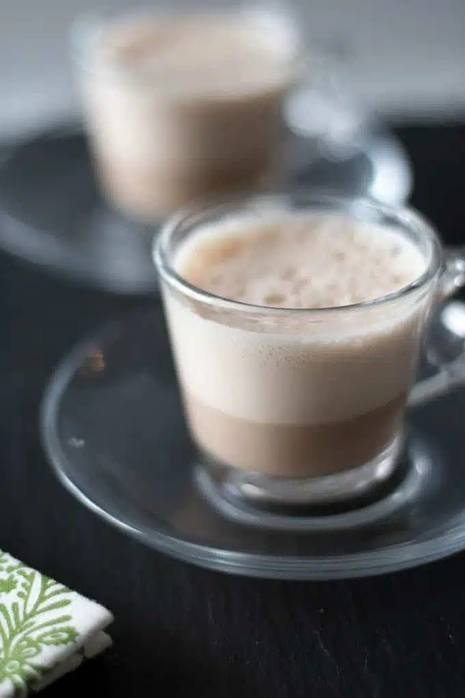 Hot beverage served in glass mug.