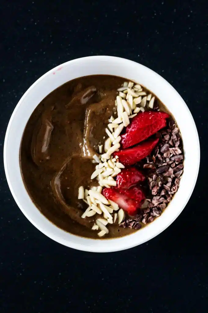 Enjoy a delicious chocolate strawberry smoothie bowl that satisfies your sweet tooth without any guilt. You’d never guess that this smoothie bowl includes a serving of greens.