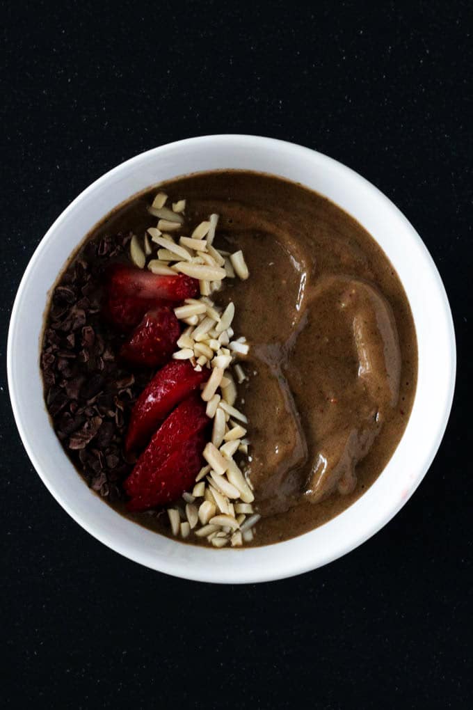 Enjoy a delicious chocolate strawberry smoothie bowl that satisfies your sweet tooth without any guilt. You’d never guess that this smoothie bowl includes a serving of greens.