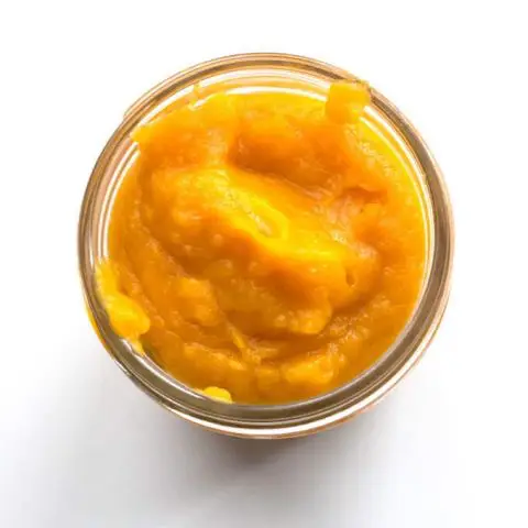 top down view of a jar filled with pumpkin puree