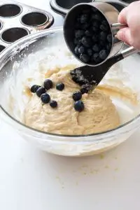 blueberries being added to bowl of batter