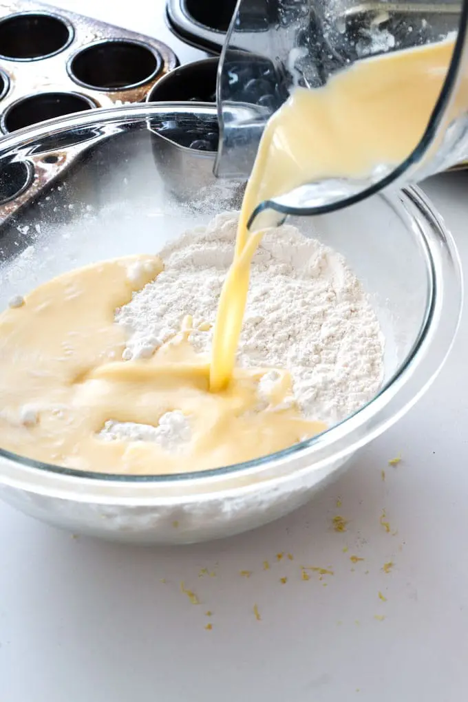 Cup of milk poured into batter.