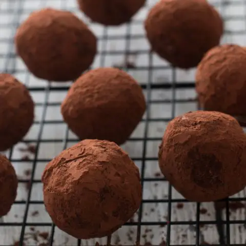cocoa covered chocolate balls on metal rack