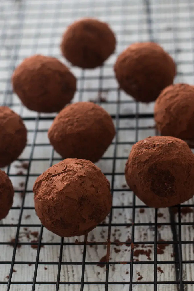 cocoa covered chocolate balls on metal rack