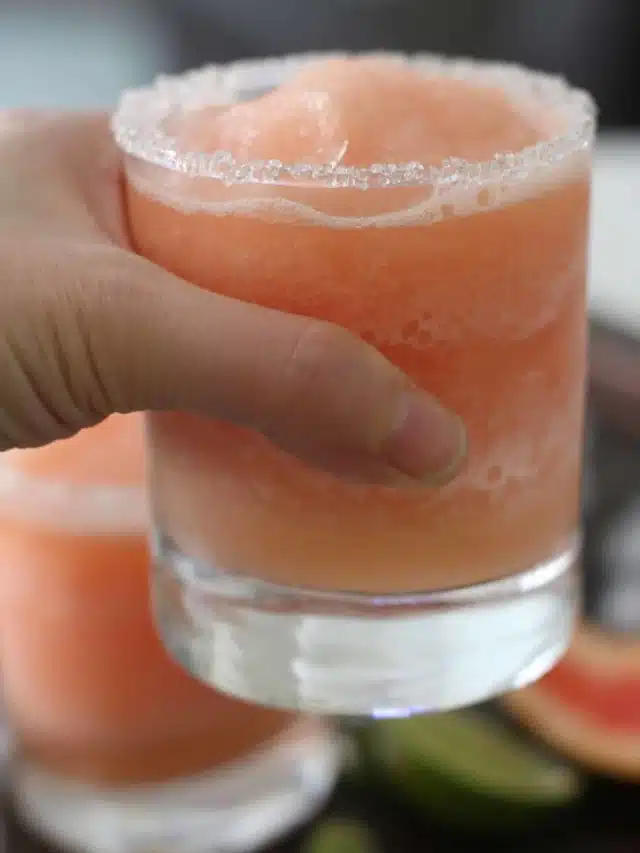 hand holding glass with blended beverage