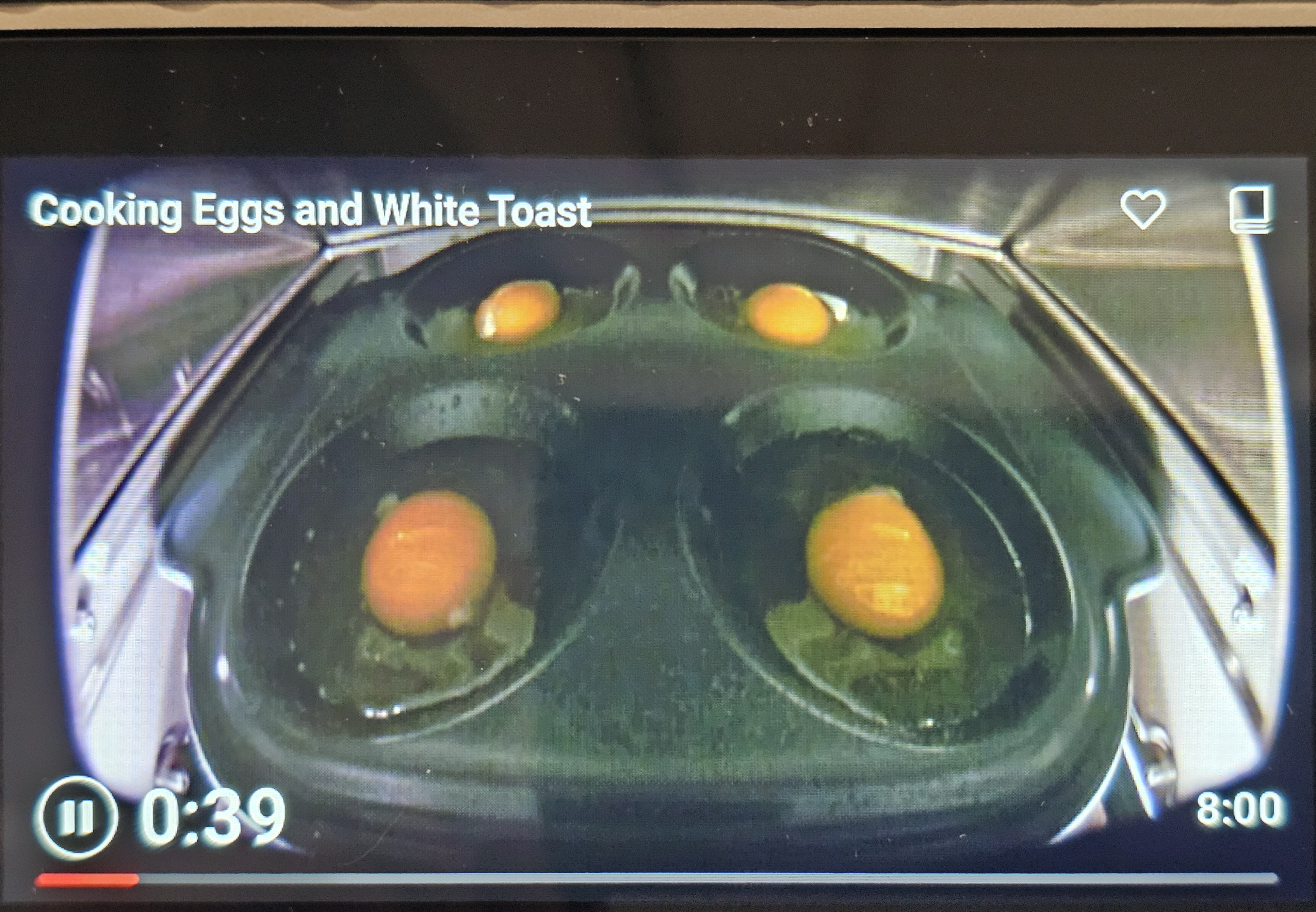Brava Oven display showing four eggs being cooked with text overlay of "Cooking Eggs and White Toast"
