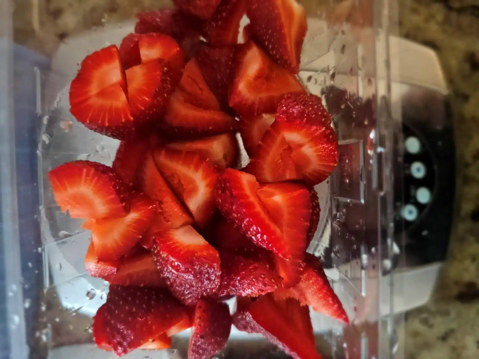 cut strawberries being weighed on a kitchen scale