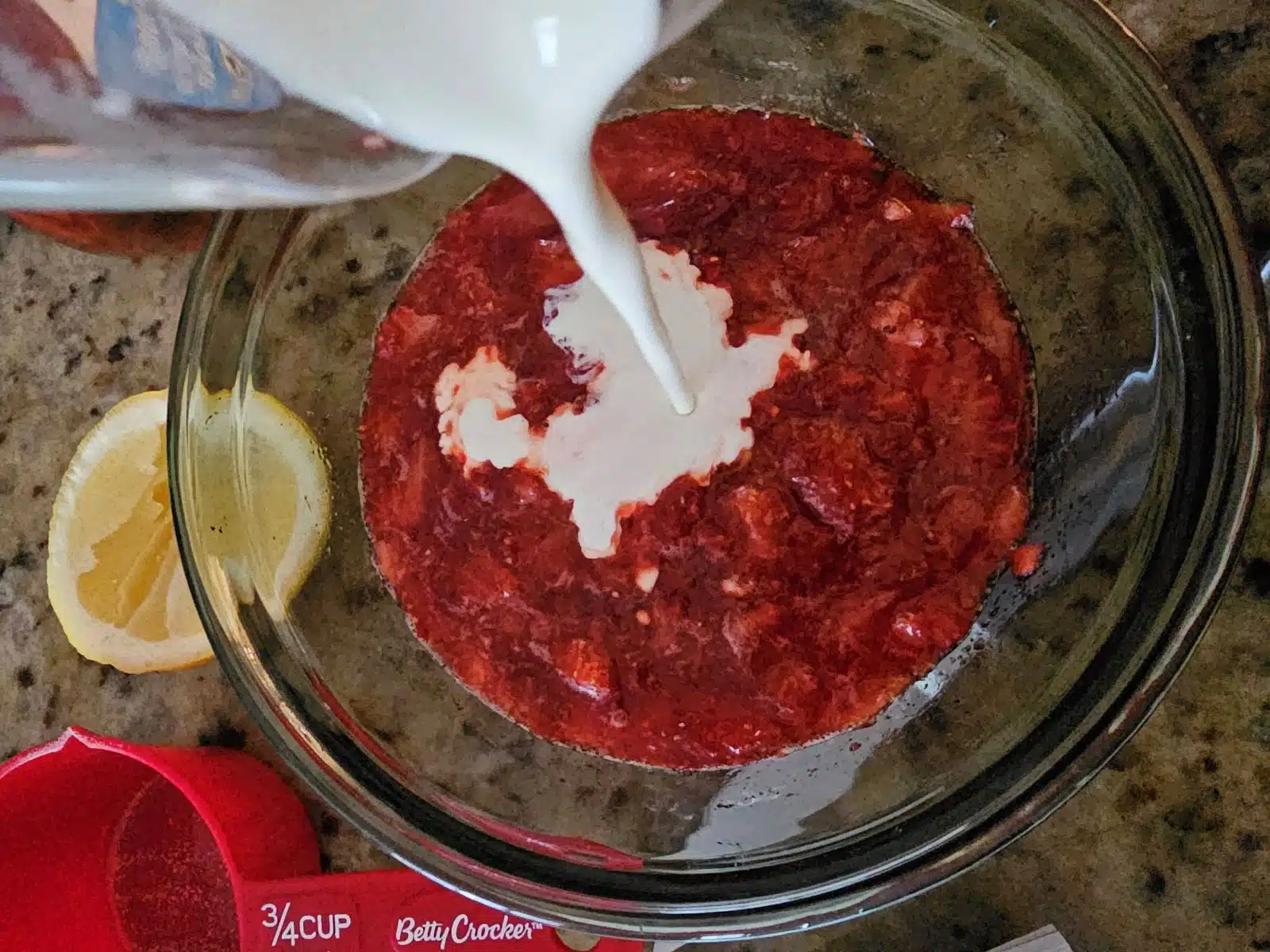 Cream being added to strawberries